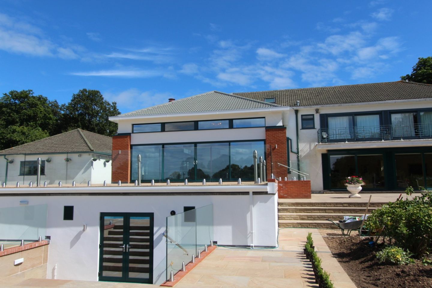 Rear extension with full-height glazing and a glass-balustraded terrace